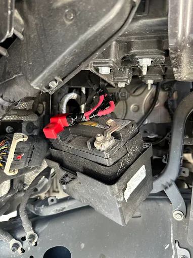 Car battery installed in its tray with the terminals connected
