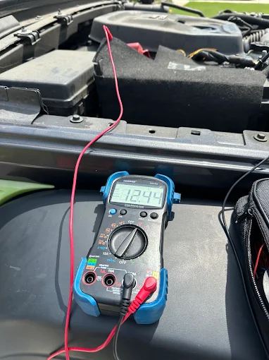 Multimeter reading 12.44 volts during a battery test